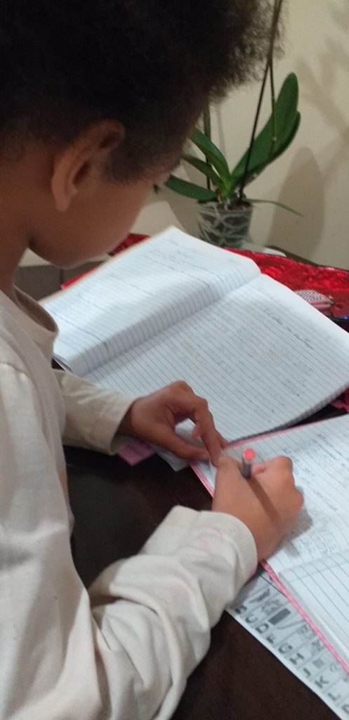 Menina escrevendo em caderno